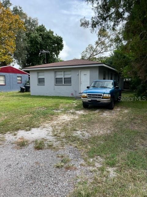 A single-story gray house with a blue pickup truck parked in the front yard — 5210 13TH AVENUE S, GULFPORT, FL