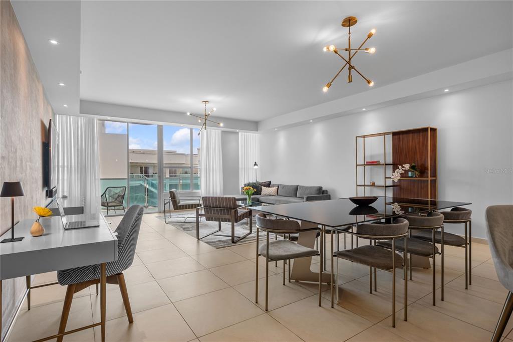 A modern open-concept living and dining area with tile floors and floor-to-ceiling windows — 25 MUNOZ RIVERA UNIT 902, SAN JUAN, PR