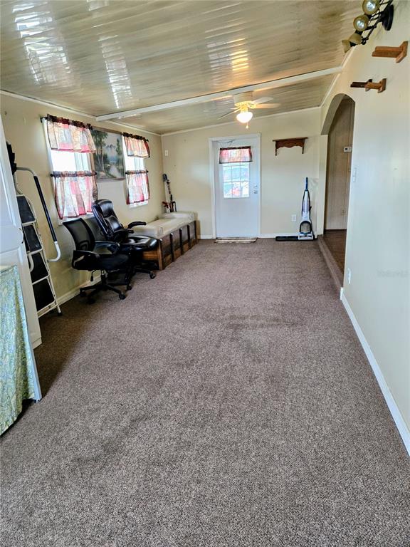 A carpeted room features a ceiling fan, a white door, and two office chairs — 6253 BALMY LANE, ZEPHYRHILLS, FL