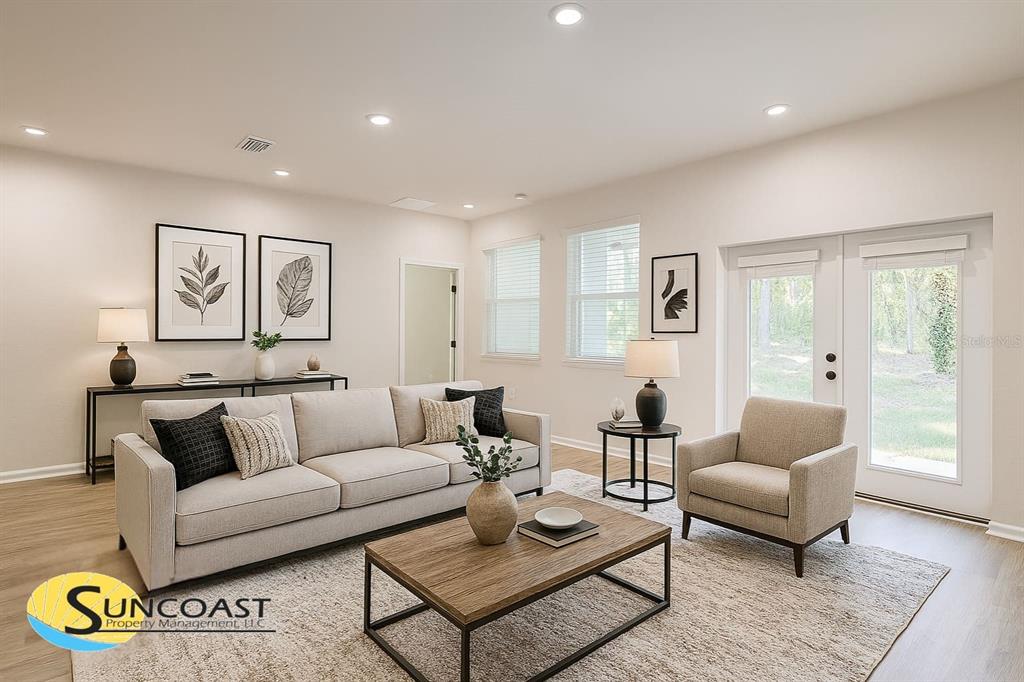 A living room features a beige sofa, an armchair, a wooden coffee table, and glass doors — 20 GREENTREE STREET, HOMOSASSA, FL