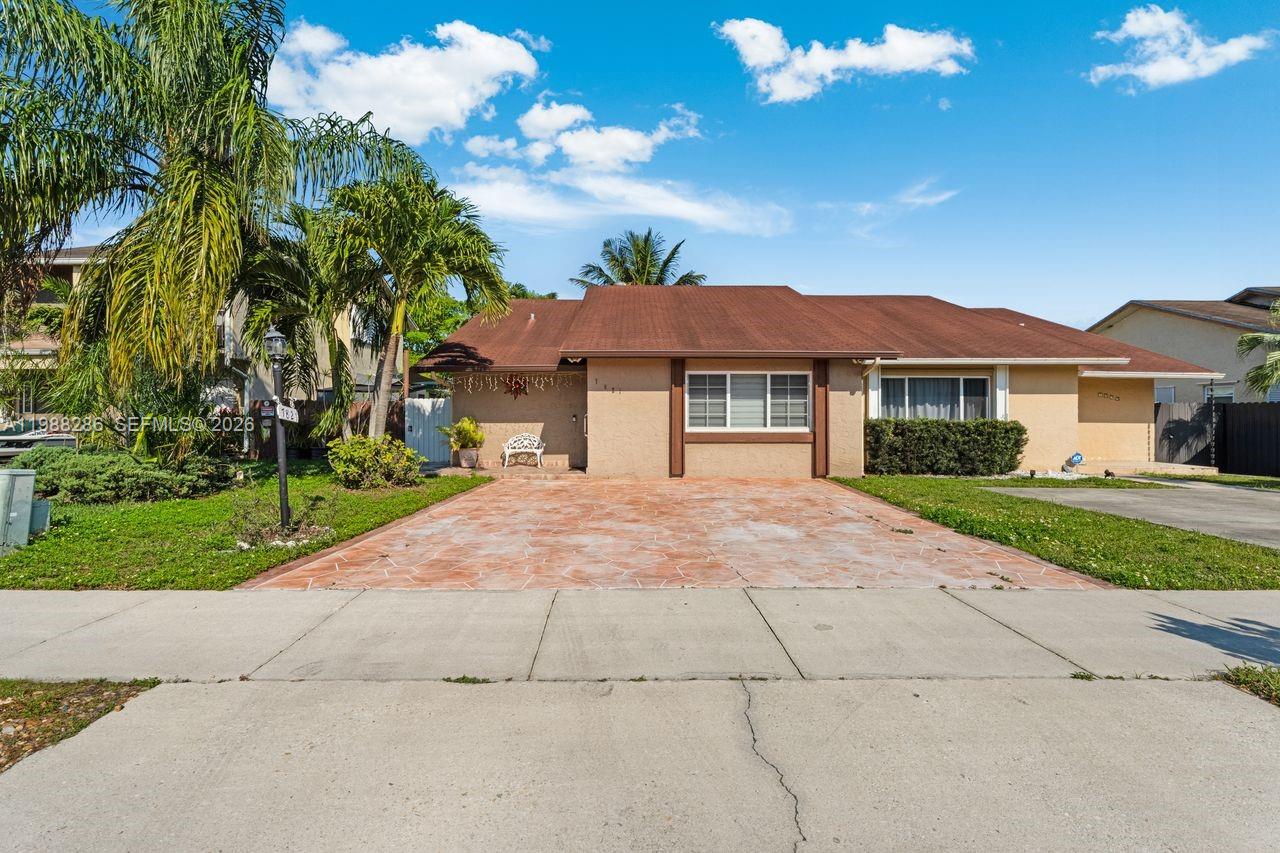 A single-story house with a brown roof, tan stucco exterior, and a paved driveway — 7821 SW 148th Ave # 2, Miami FL 33193, MIAMI, FL