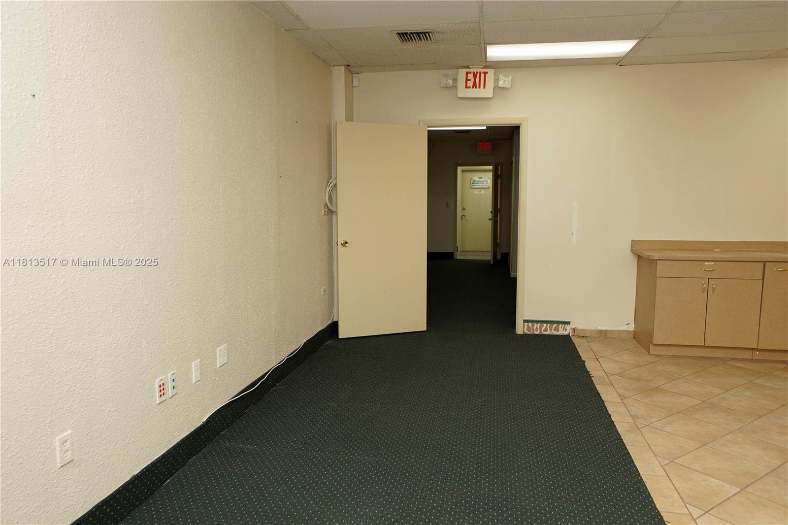 An office space features a carpeted floor, a beige cabinet, and an open doorway — 8500 SW 40th St, Miami FL 33155, MIAMI, FL