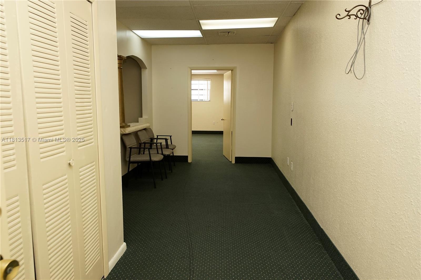A small office waiting area features green carpet, two chairs, and a doorway to another room — 8500 SW 40th St, Miami FL 33155, MIAMI, FL