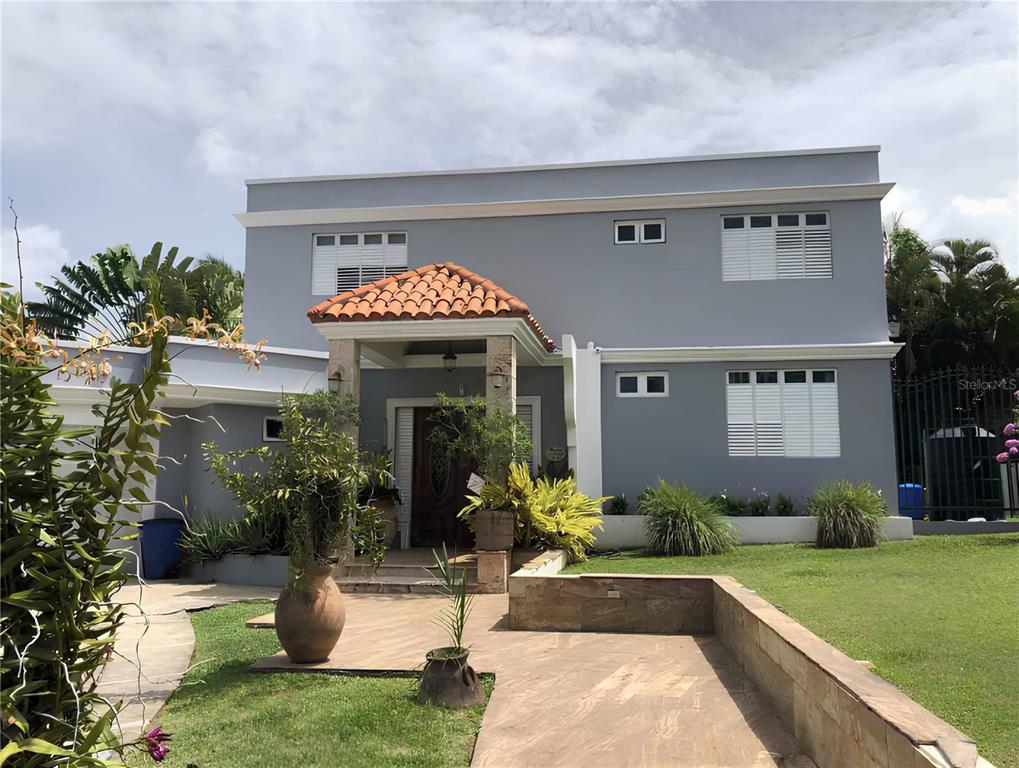 A two-story gray house with a tiled entryway roof and a stone-paved front patio — J2 CHURCH STREET, GUAYNABO, PR