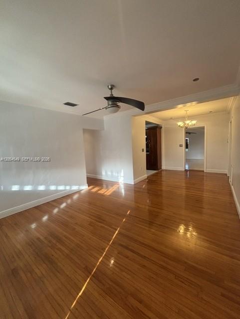 An empty room features hardwood floors, a ceiling fan, and an open doorway to another room — 14590 NW 10th Ave, Miami FL 33168, MIAMI, FL