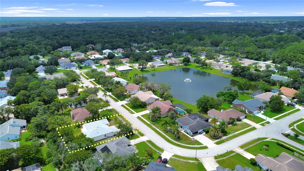 An aerial view shows a residential neighborhood with a central pond and a highlighted house — 516 SUN LAKE DRIVE, PORT ORANGE, FL