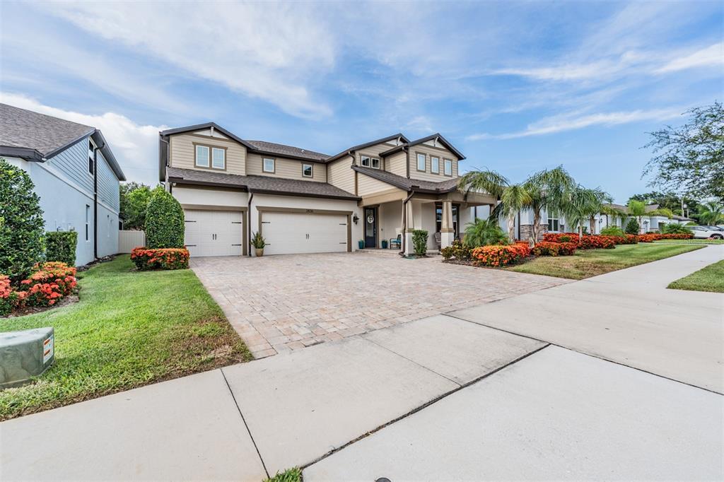 A two-story suburban house with a paved driveway, three-car garage, and landscaped front yard — 2836 BUCKHORN FOREST DRIVE, VALRICO, FL