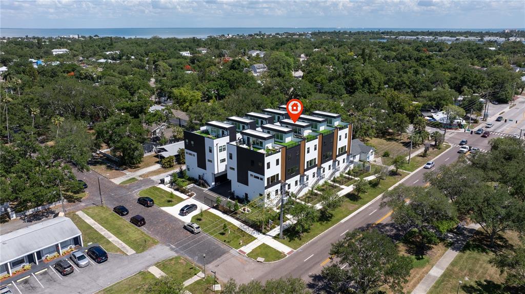 An aerial view shows a modern multi-unit residential building with flat roofs and balconies — 2104 4TH STREET S UNIT 3, ST PETERSBURG, FL