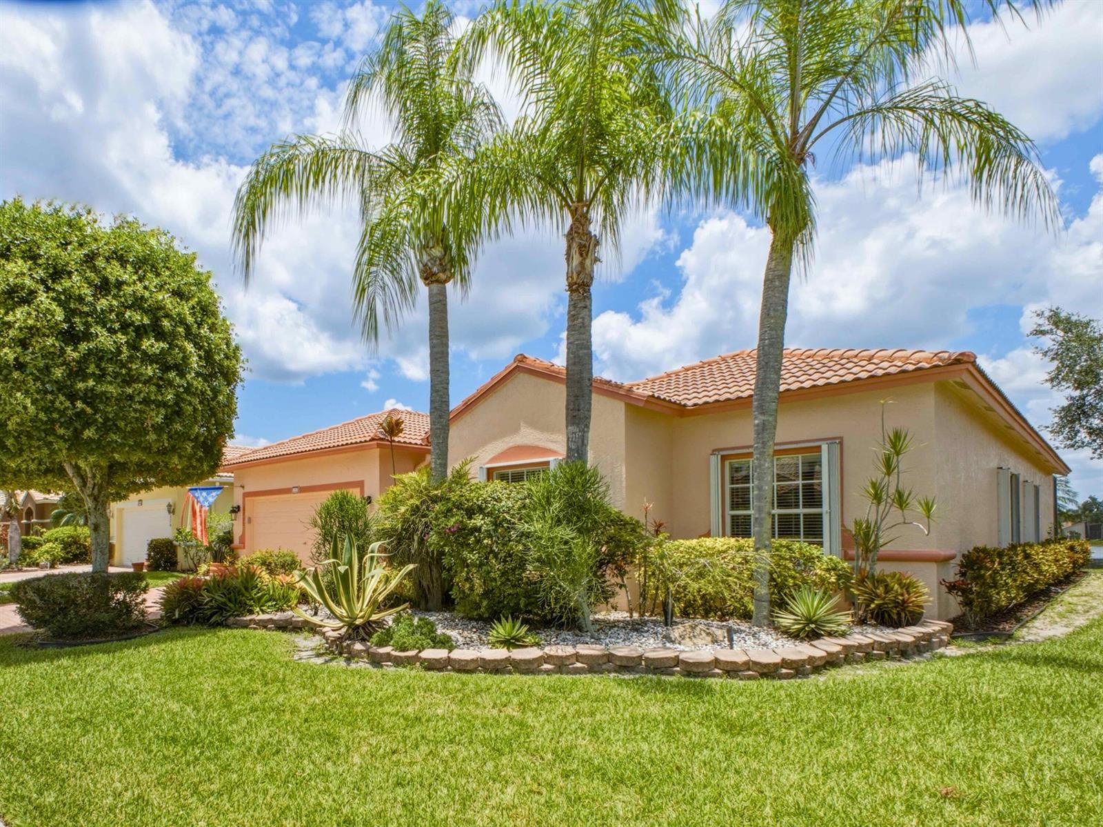 A single-story stucco house with a tile roof, palm trees, and a landscaped front yard — 8328 GRAND MESSINA Circle, Boynton Beach FL 33472, BOYNTON BEACH, FL