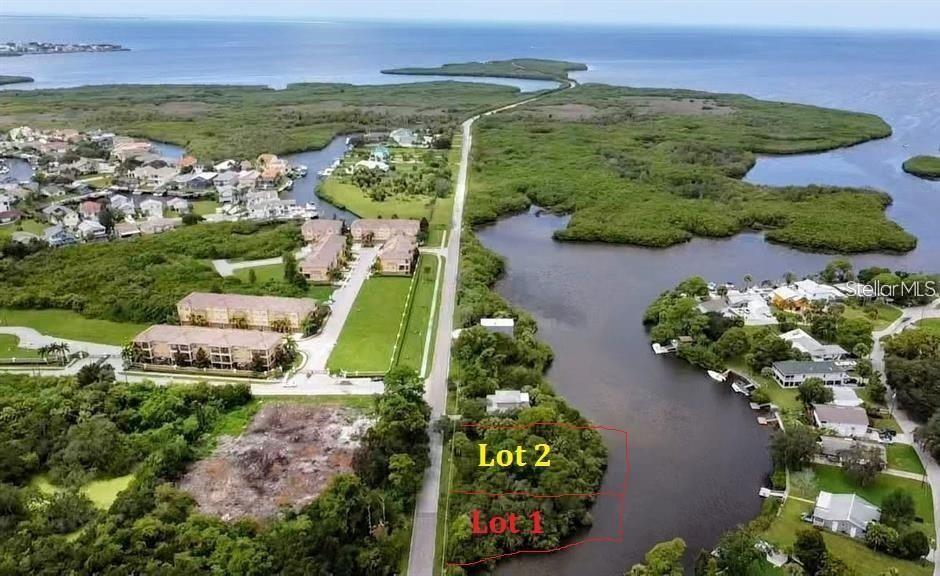 An aerial view shows two adjacent waterfront lots outlined in red along a coastal road — 1-2 GREEN KEY, NEW PORT RICHEY, FL
