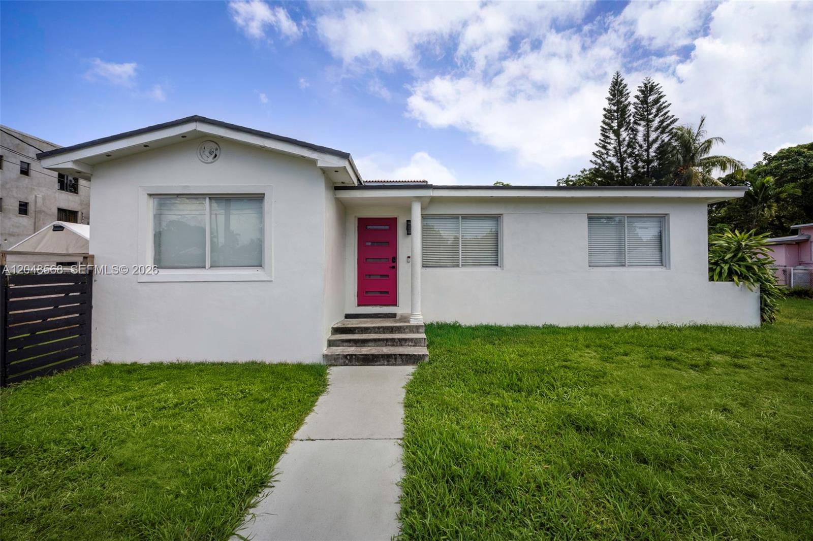 A white single-story house features a bright pink front door and a concrete walkway — 0-2939 SW 5th St, Miami FL 33135, MIAMI, FL
