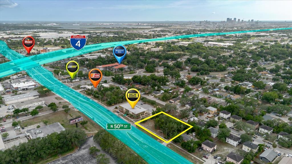 This aerial map shows a vacant lot highlighted in yellow near a highway intersection — 3206 N 50TH STREET, TAMPA, FL