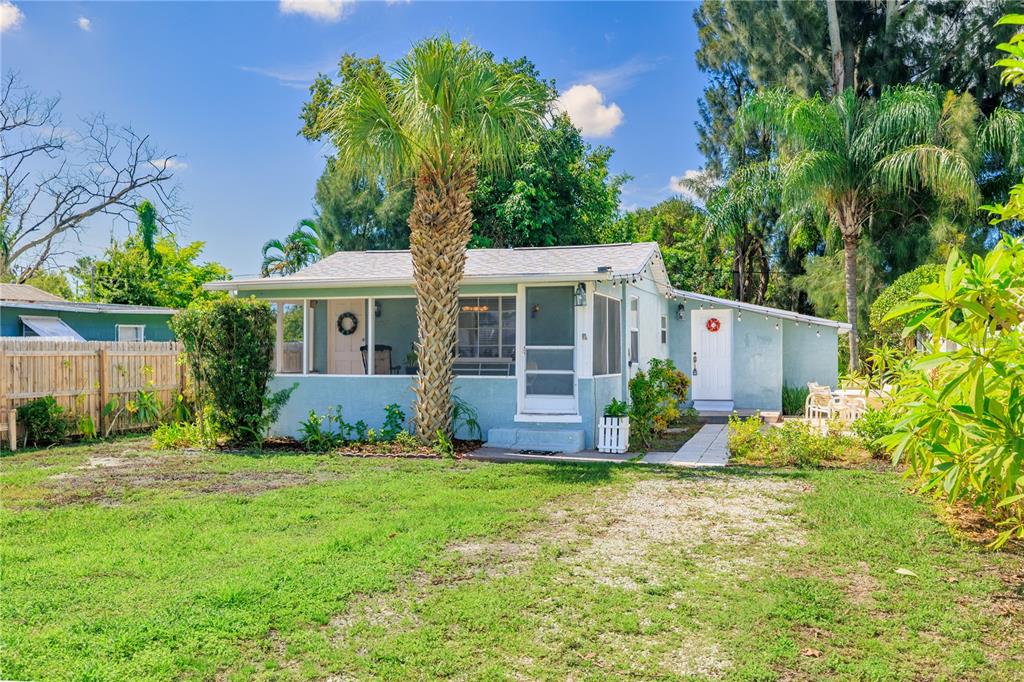 A light blue single-story house with a palm tree in the front yard — 6634 49TH AVENUE N, ST PETERSBURG, FL