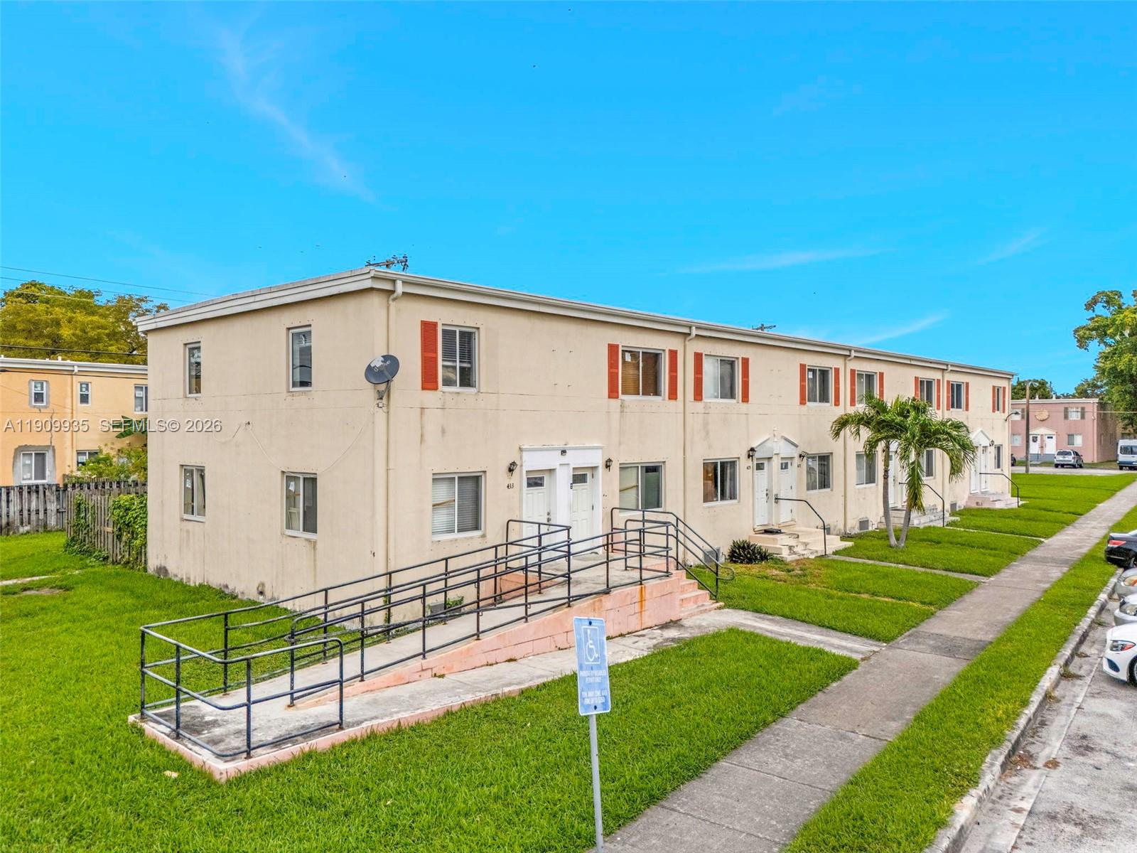 A two-story apartment building features a wheelchair ramp and a handicap parking sign — 427 NW 84th Ter # 427, Miami FL 33150, MIAMI, FL
