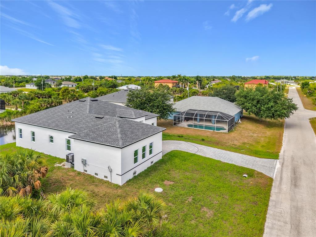 A white stucco house exterior features a double front door, a garage, and paver driveway — 14382 FORT WORTH CIRCLE, PORT CHARLOTTE, FL
