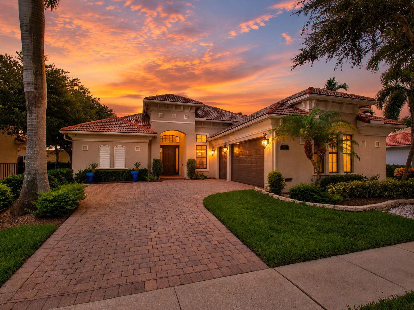 A single-story house with a tiled roof and brick driveway at sunset — 16211 Rosecroft Terrace, Delray Beach FL 33446, DELRAY BEACH, FL