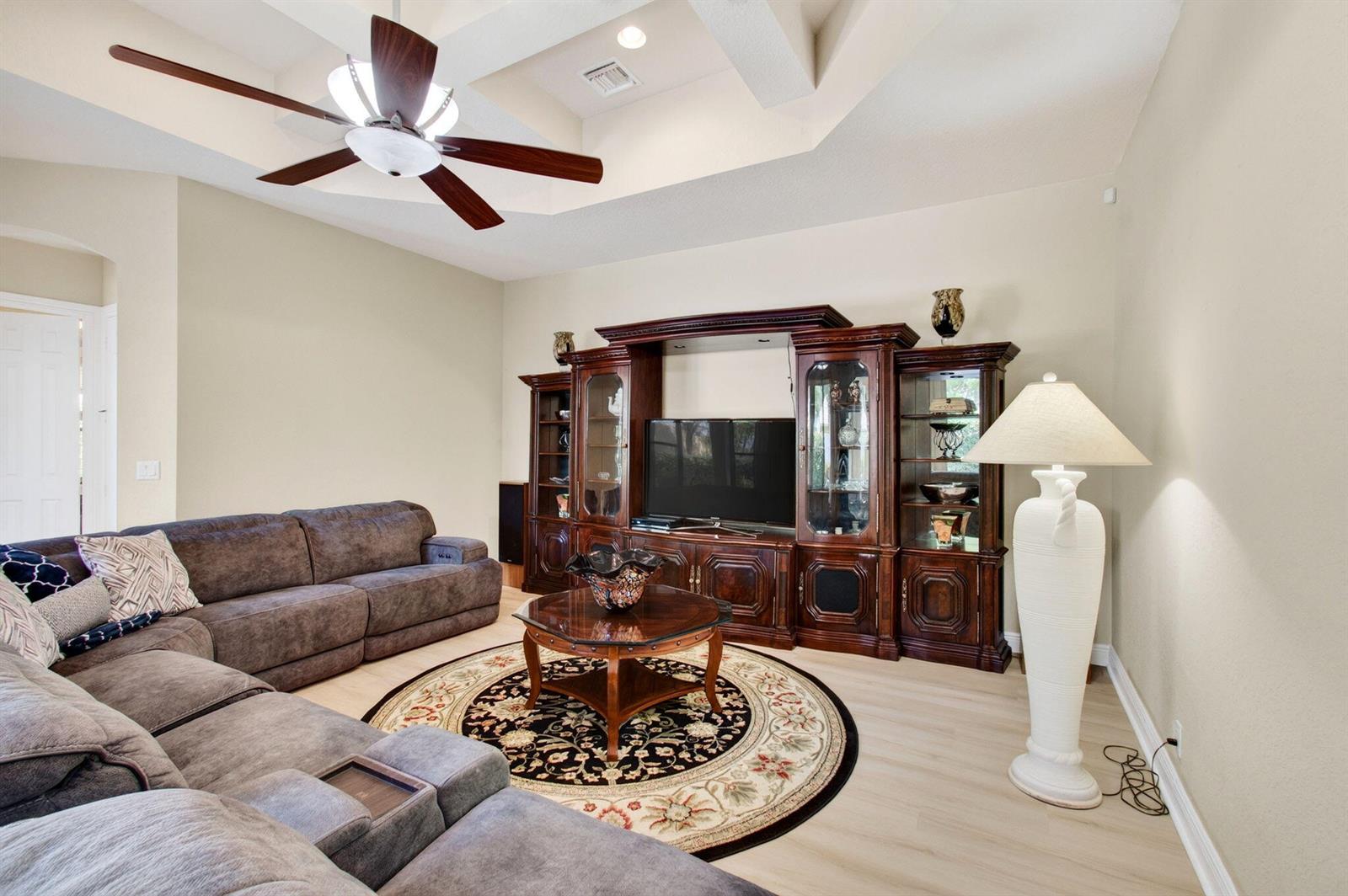 A living room features a large sectional sofa, a wooden entertainment center, and a ceiling fan — 16211 Rosecroft Terrace, Delray Beach FL 33446, DELRAY BEACH, FL
