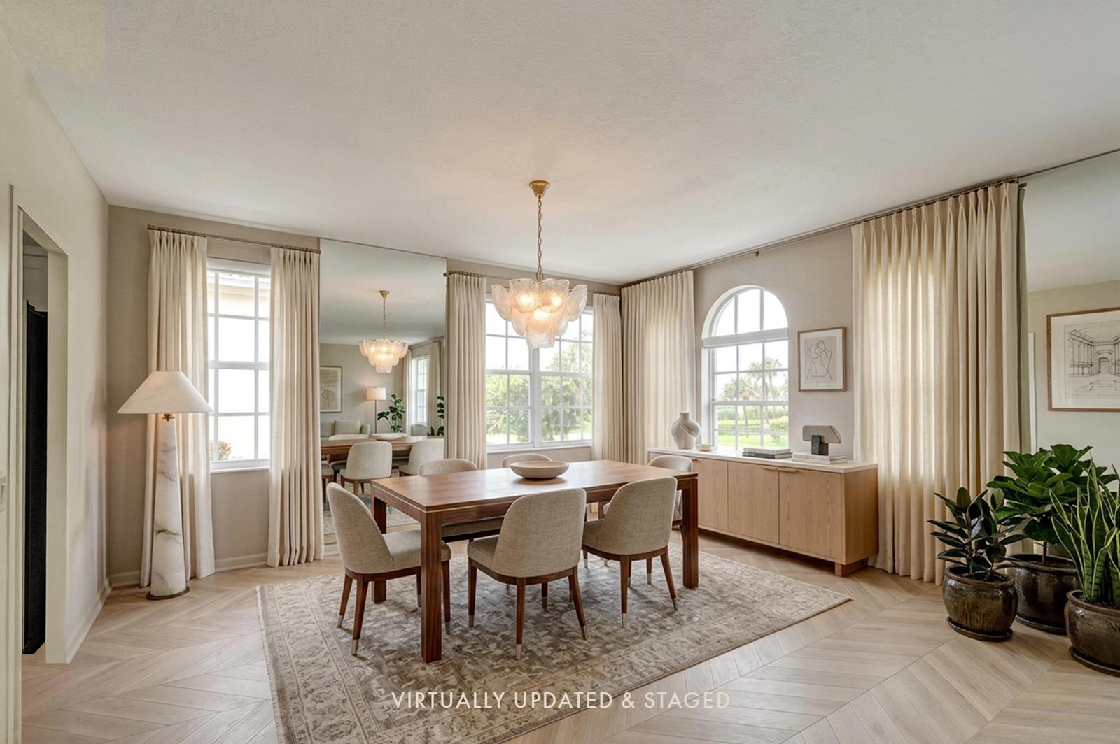 A dining room with a wooden table, chairs, large mirrors, and arched windows — 3475 S Ocean Boulevard # 116, Palm Beach FL 33480, PALM BEACH, FL