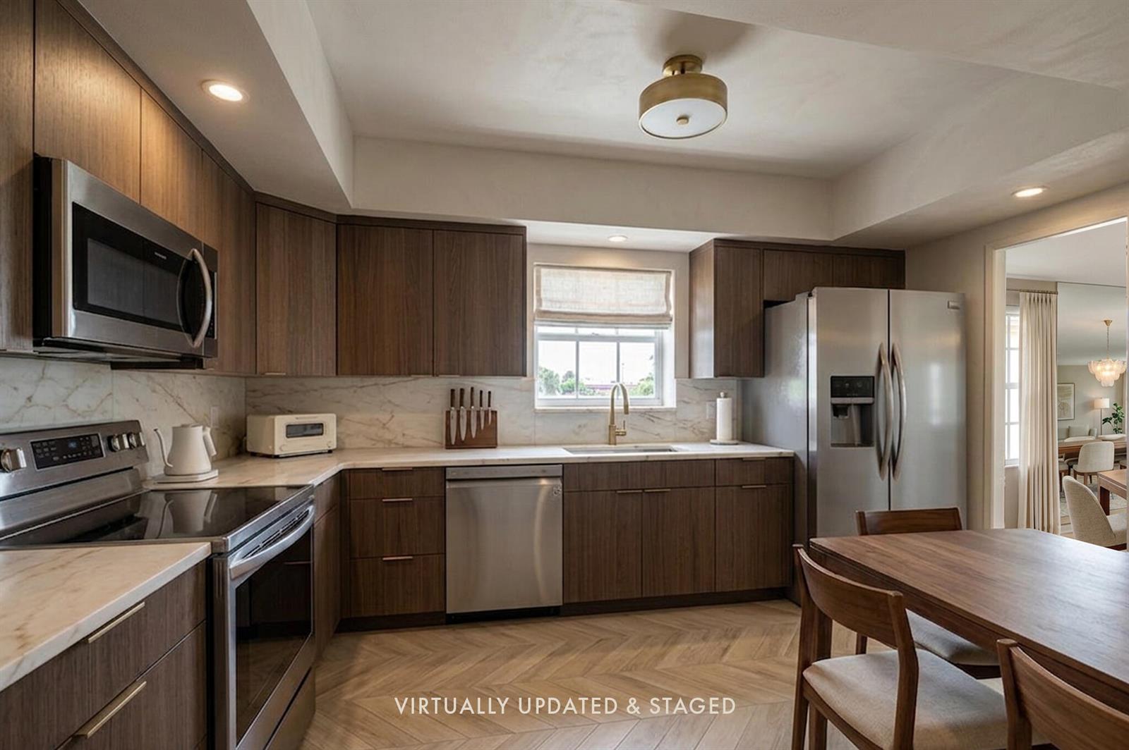 A kitchen with wood cabinets, stainless steel appliances, marble countertops, and herringbone wood-look flooring — 3475 S Ocean Boulevard # 116, Palm Beach FL 33480, PALM BEACH, FL