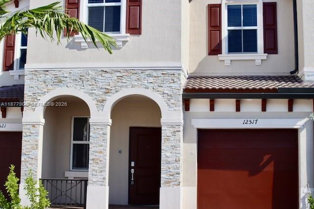 A modern kitchen features white cabinets, stainless steel appliances, and a central island with countertops — 12517 NW 23rd Pl, Miami FL 33167, MIAMI, FL