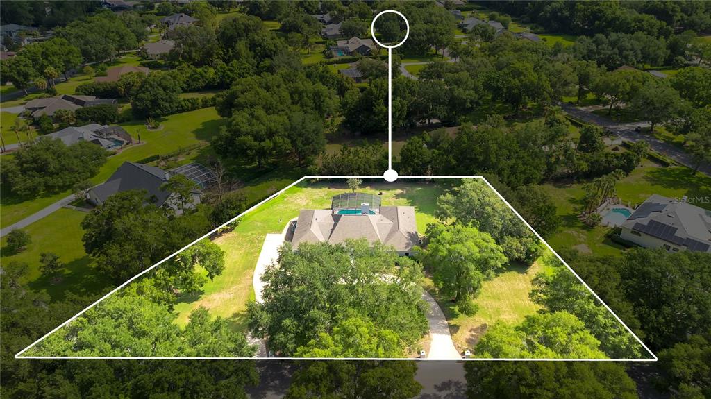 An aerial view shows a single-story house with a pool enclosure on a large lot — 8368 RAMBLING RIVER DRIVE, SANFORD, FL