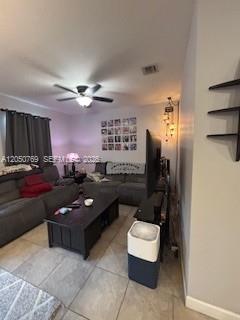 A living room features gray sofas, a dark coffee table, and a ceiling fan — 162 SE 33rd Ter, Homestead FL 33033, HOMESTEAD, FL