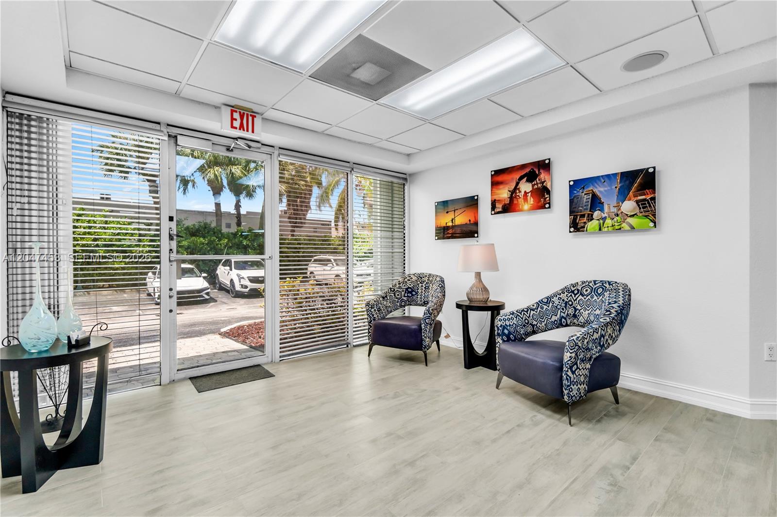A waiting area features two patterned armchairs, a side table, wall art, and glass doors — 16155 SW 117th Ave # B17, Miami FL 33177, MIAMI, FL