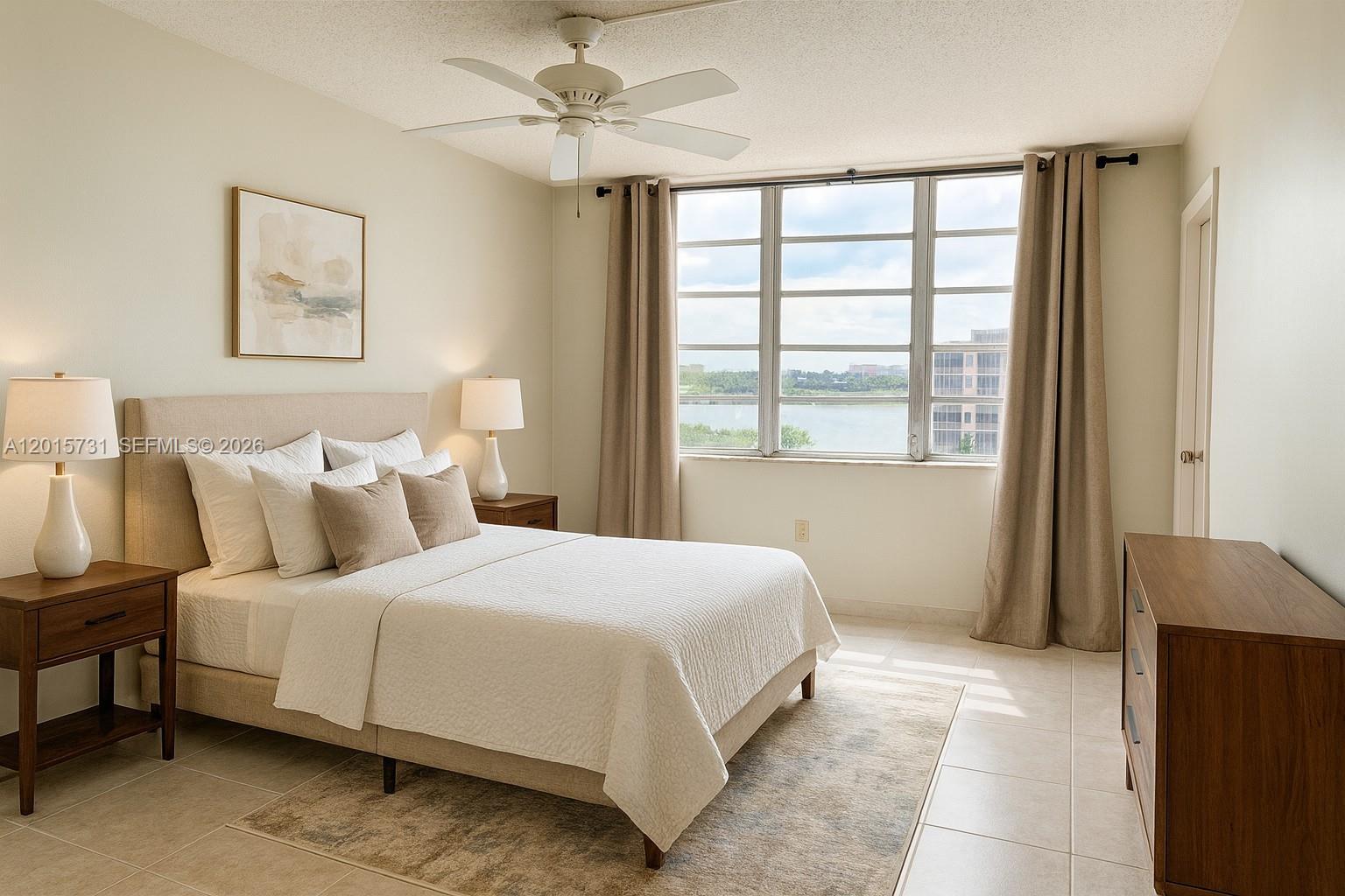 A bedroom features a bed, two nightstands, a dresser, and a large window with water views — 1750 NE 191st St # 3, Miami FL 33179, MIAMI, FL