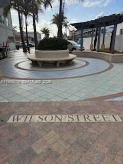 A circular stone bench surrounds a central planter in a paved outdoor plaza — 321 Wilson St # A204, Hollywood FL 33019, HOLLYWOOD, FL