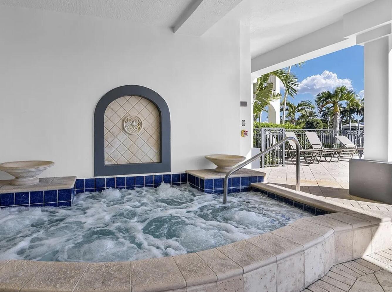 A bubbling hot tub sits on a tiled patio under a covered outdoor area — 3042 WATERSIDE Circle, Boynton Beach FL 33435, BOYNTON BEACH, FL