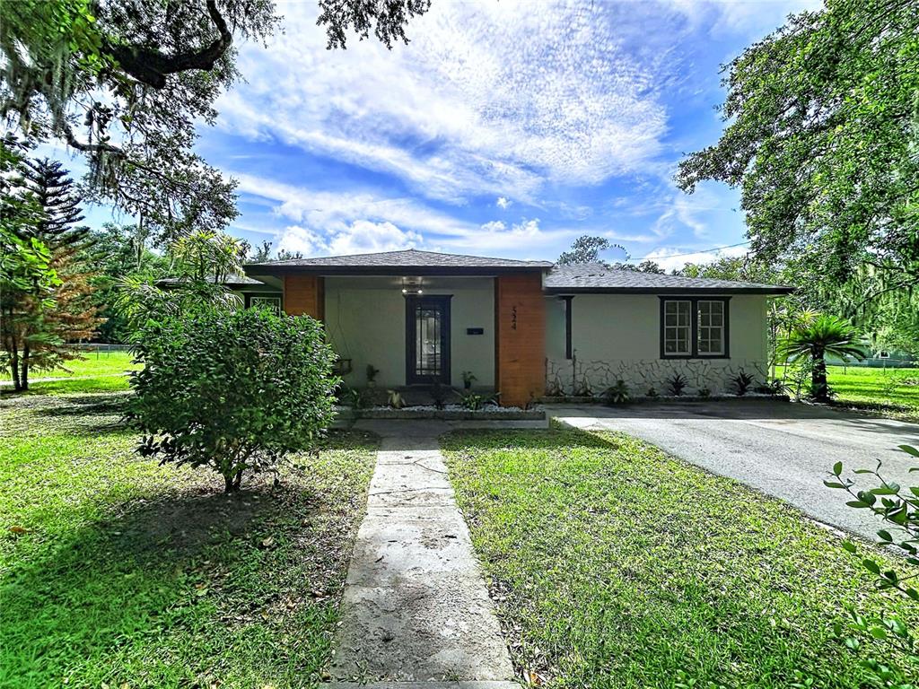 A single-story house with a brick entryway, stone facade, and a concrete walkway — 524 EAST AVENUE, BROOKSVILLE, FL