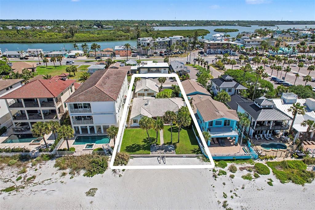 An aerial view shows a beachfront property with a house and lawn outlined in white — 18206 SUNSET BOULEVARD, REDINGTON SHORES, FL