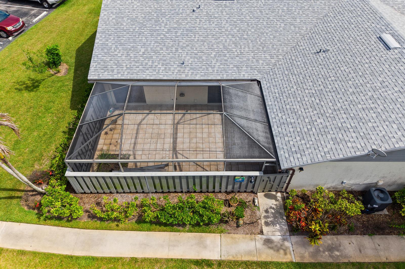 An aerial view shows a house with a screened-in patio and a fenced backyard — 1327 Peppertree Trail Unit A, Fort Pierce FL 34950, FORT PIERCE, FL