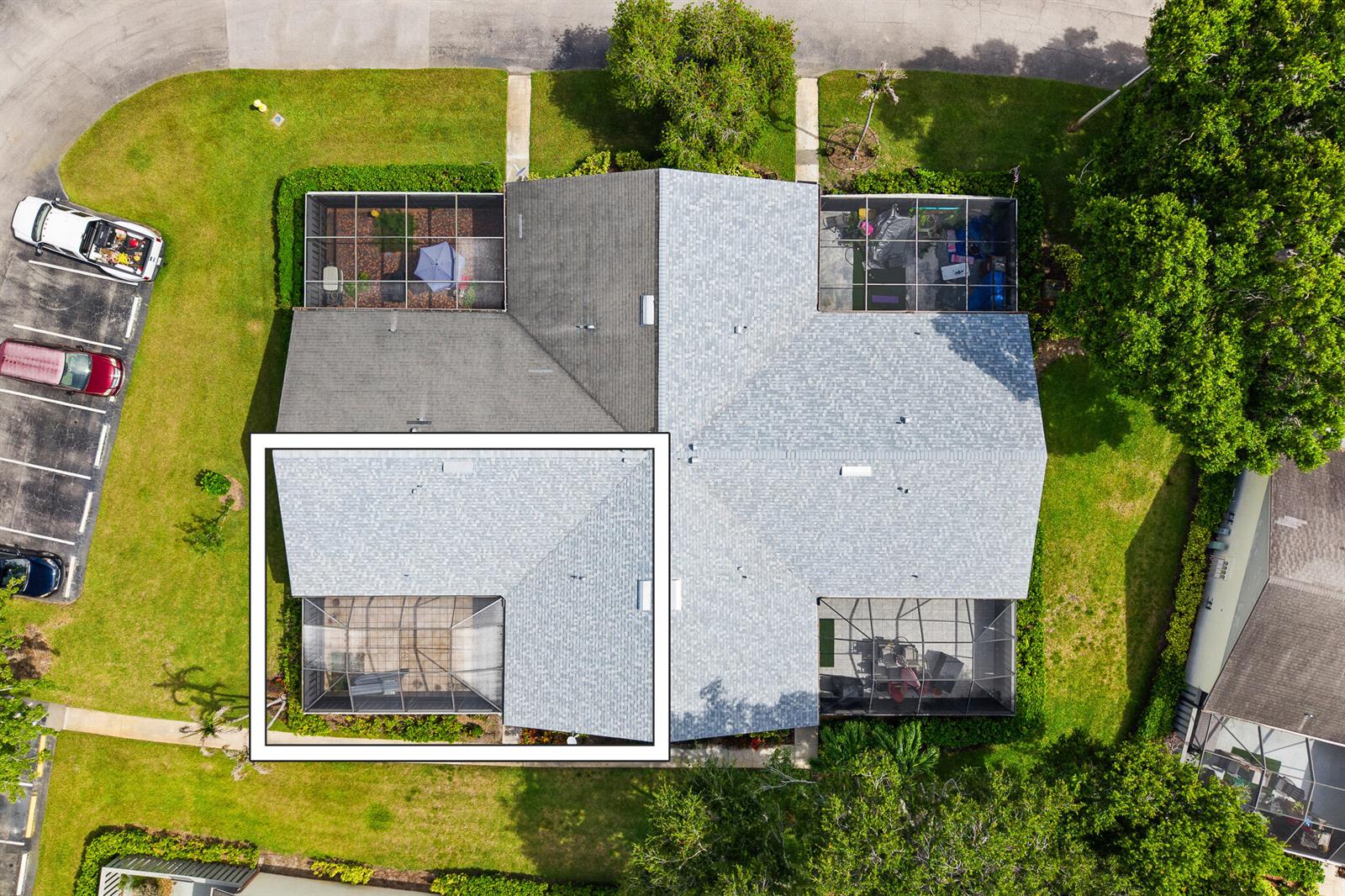 An aerial view shows a residential house with multiple screened-in lanais and a shingled roof — 1327 Peppertree Trail Unit A, Fort Pierce FL 34950, FORT PIERCE, FL