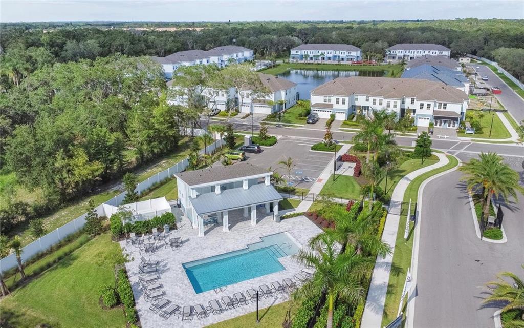 An aerial view shows a swimming pool, a covered patio, and multi-story residential buildings — 4020 VIA SIENNA CIRCLE, SARASOTA, FL
