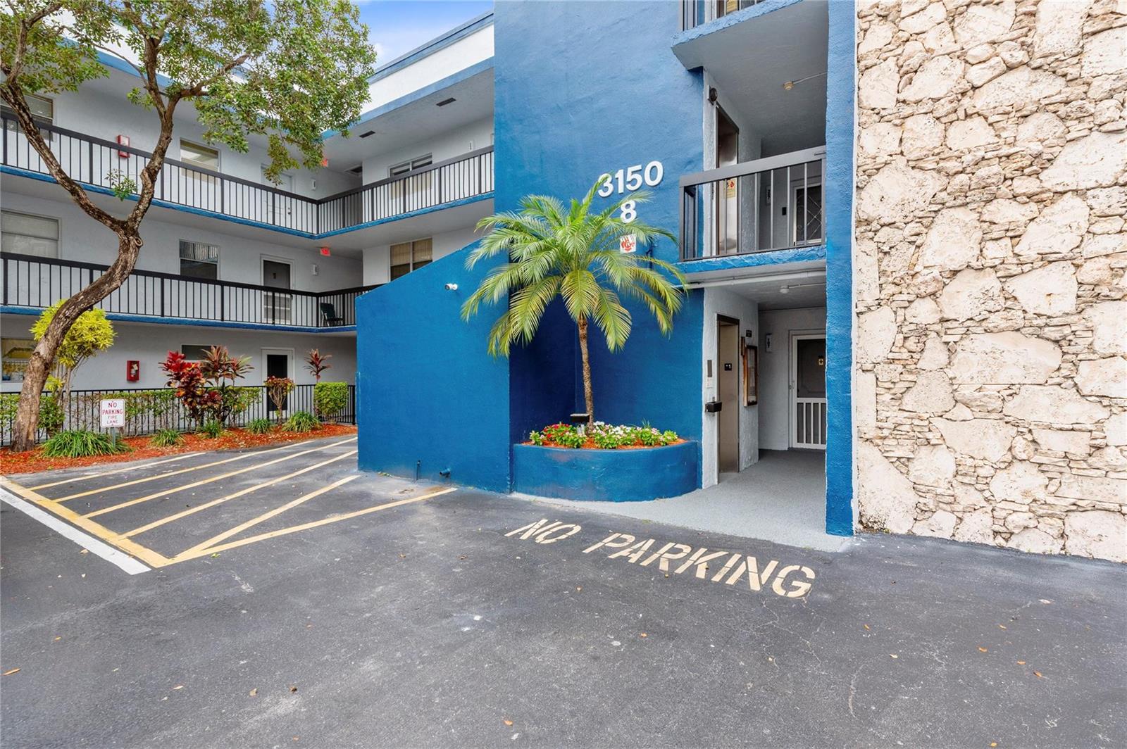 An entryway features a checkered tile floor, a black console table, and a model ship — 3150 Holiday Springs Boulevard # 308, Margate FL 33063, MARGATE, FL
