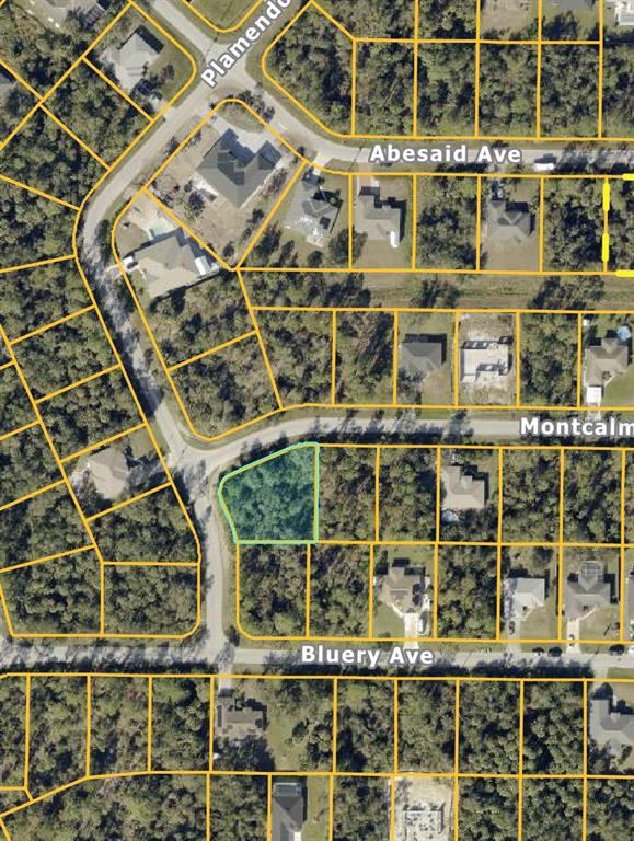 This is an aerial map view of a wooded residential lot highlighted in light blue — MONTCALM AVENUE, NORTH PORT, FL