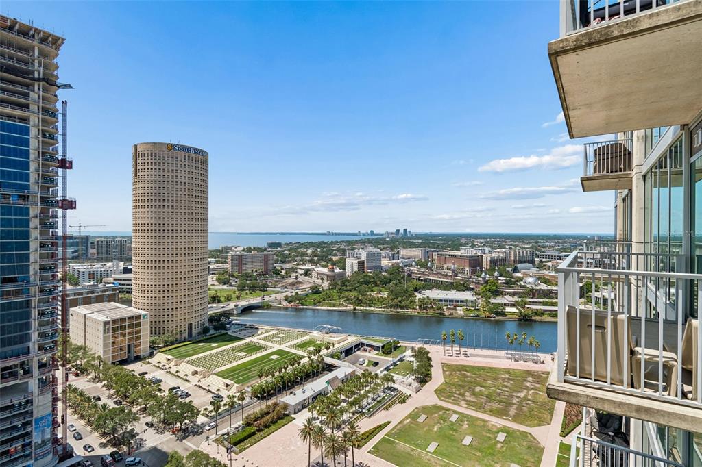An elevated view of a city skyline, river, and park from a high-rise balcony — 777 N ASHLEY DRIVE UNIT 2308, TAMPA, FL