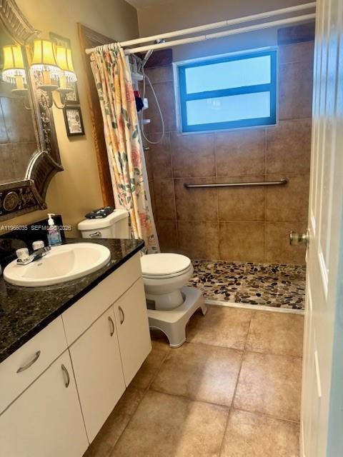 A bathroom features a vanity with a granite countertop, a toilet, and a walk-in shower — 1481 SW 7th Ter, Deerfield Beach FL 33441, DEERFIELD BEACH, FL