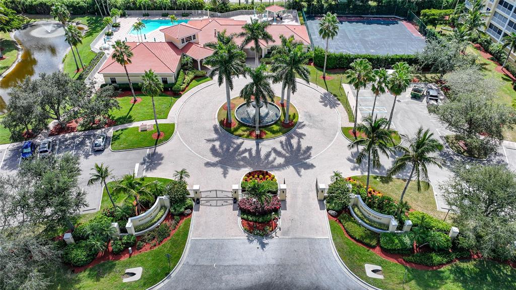 An aerial view shows a gated community entrance with a circular fountain and palm trees — 255 W END DRIVE UNIT 3306, PUNTA GORDA, FL
