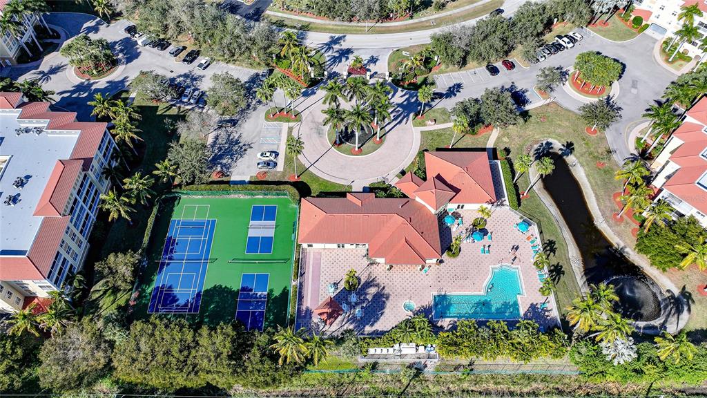 An aerial view shows a community clubhouse with a swimming pool and two tennis courts — 255 W END DRIVE UNIT 3306, PUNTA GORDA, FL