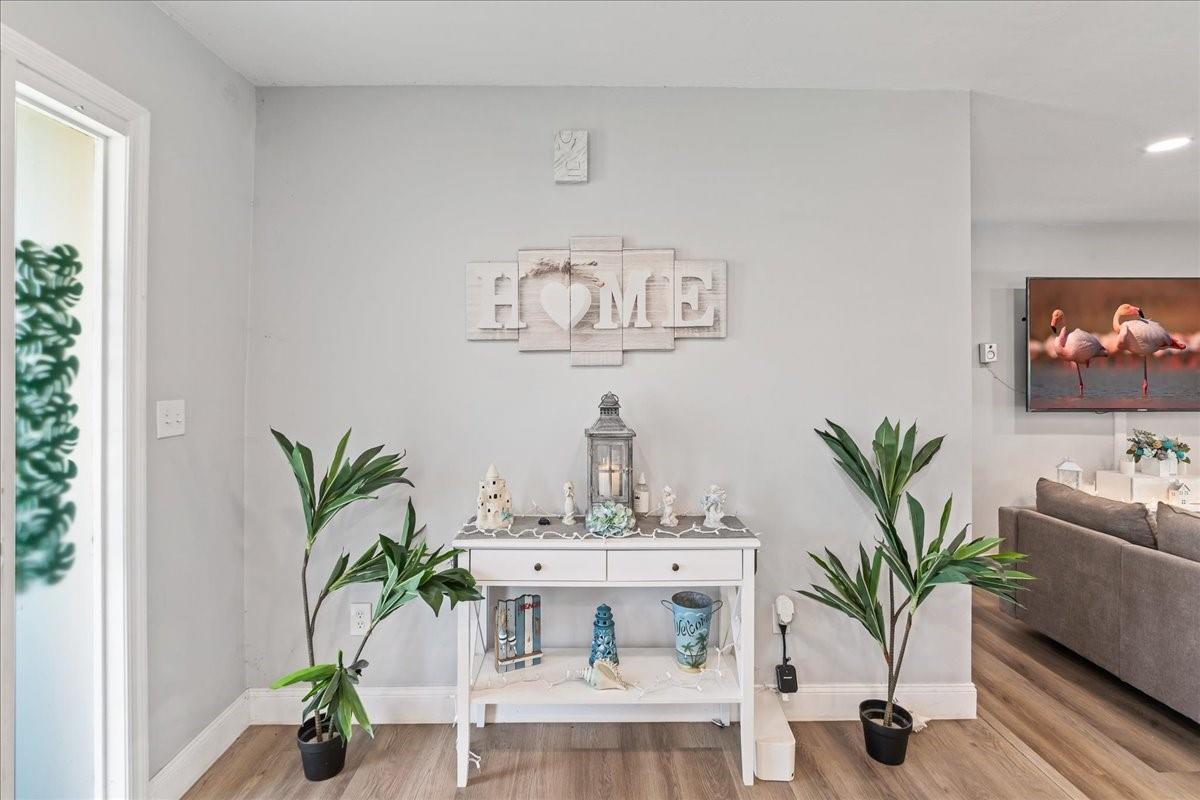 A white console table with decor sits against a light gray wall under a sign — 573 Wimbrow Drive, Sebastian FL 32958, SEBASTIAN, FL