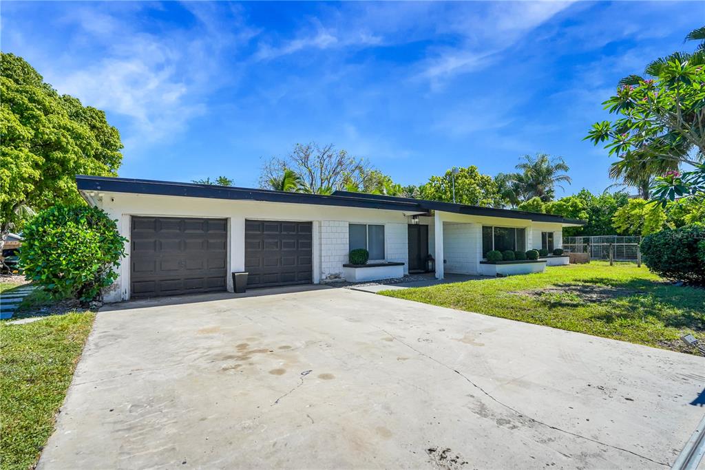 A single-story house with a two-car garage, white brick exterior, and a concrete driveway — 19755 SW 241ST TERRACE, HOMESTEAD, FL