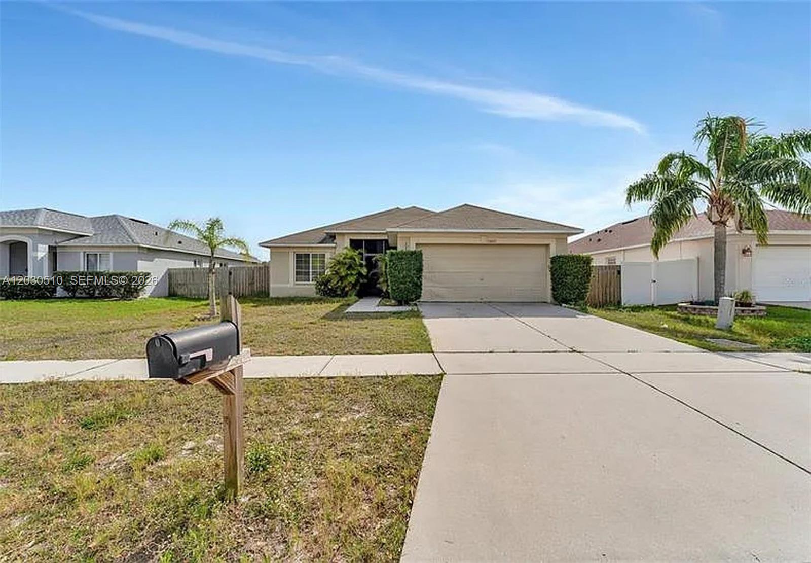 A single-story house with a beige exterior, a two-car garage, and a front lawn — 11007 Whitecap Dr, Riverview FL 33579, RIVERVIEW, FL