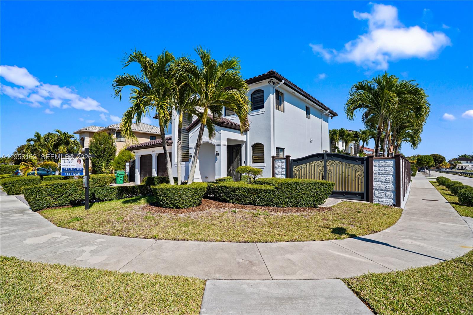 A two-story white house with a gated driveway and palm trees in the front yard — 3281 SW 145th Ave, Miami FL 33175, MIAMI, FL