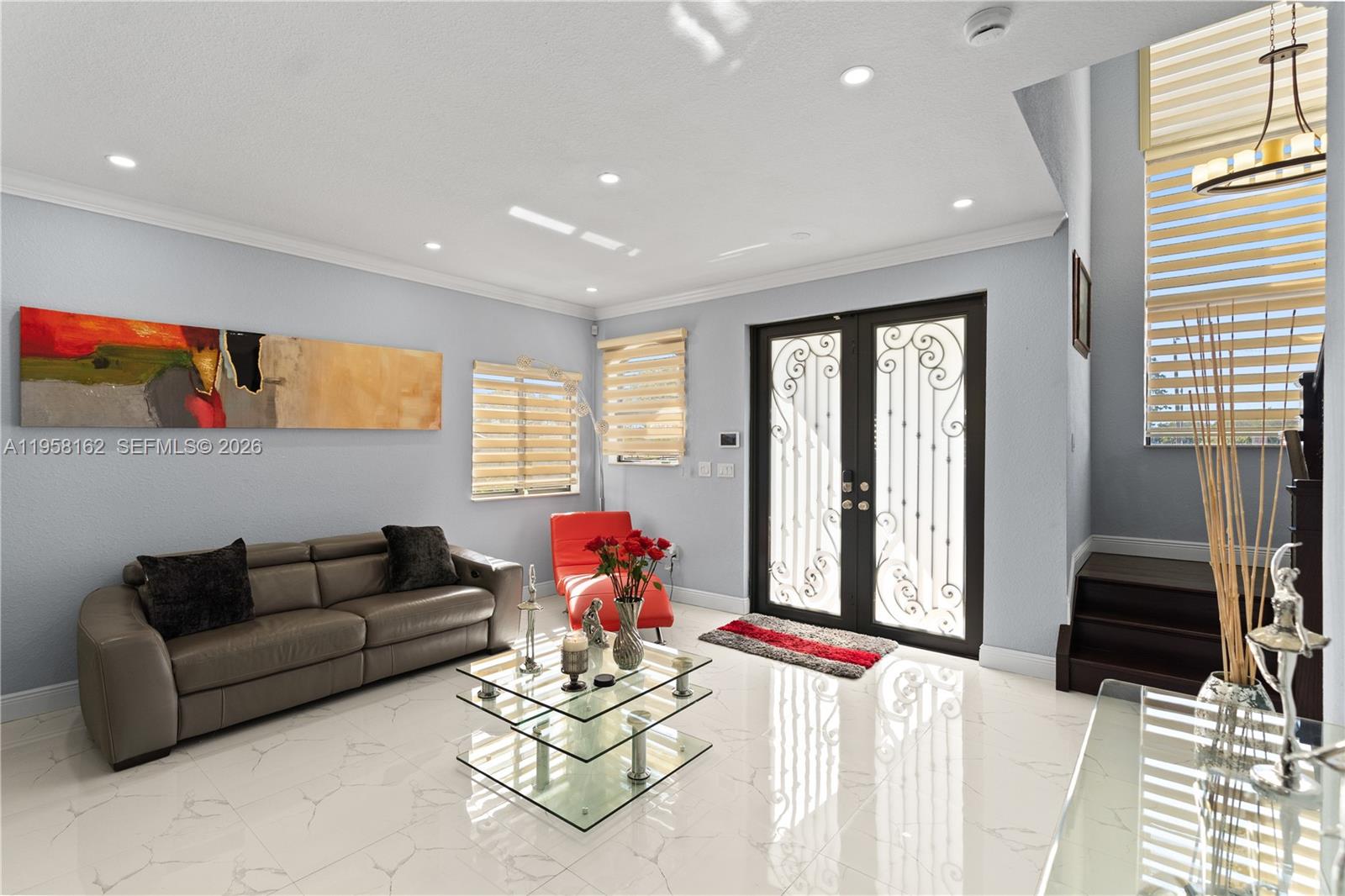 A living room features a grey sofa, glass coffee table, and double glass-paneled entry doors — 3281 SW 145th Ave, Miami FL 33175, MIAMI, FL