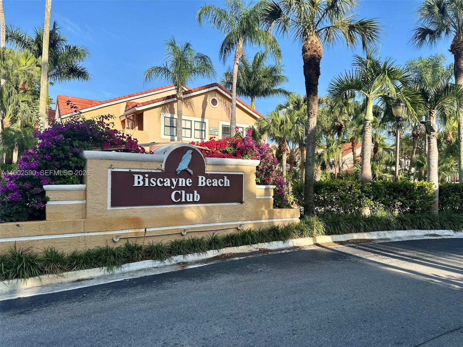 A sign for Biscayne Beach Club stands in front of a multi-story residential building — 10581 SW 155th Ct # 1214, Miami FL 33196, MIAMI, FL