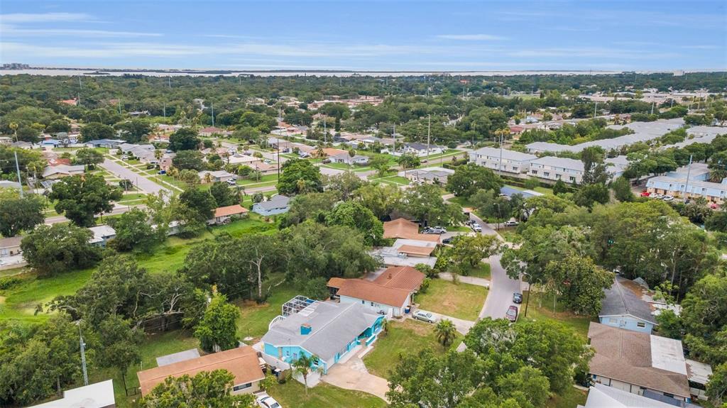 An aerial view of a suburban neighborhood featuring a bright blue house with a pool — 1948 BYRAM DRIVE, CLEARWATER, FL