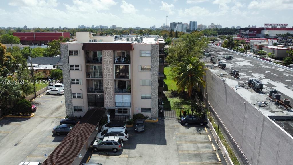 An aerial view shows a multi-story apartment building with a parking lot and surrounding urban area — 3640 NW 9th St # 201, Miami FL 33125, MIAMI, FL