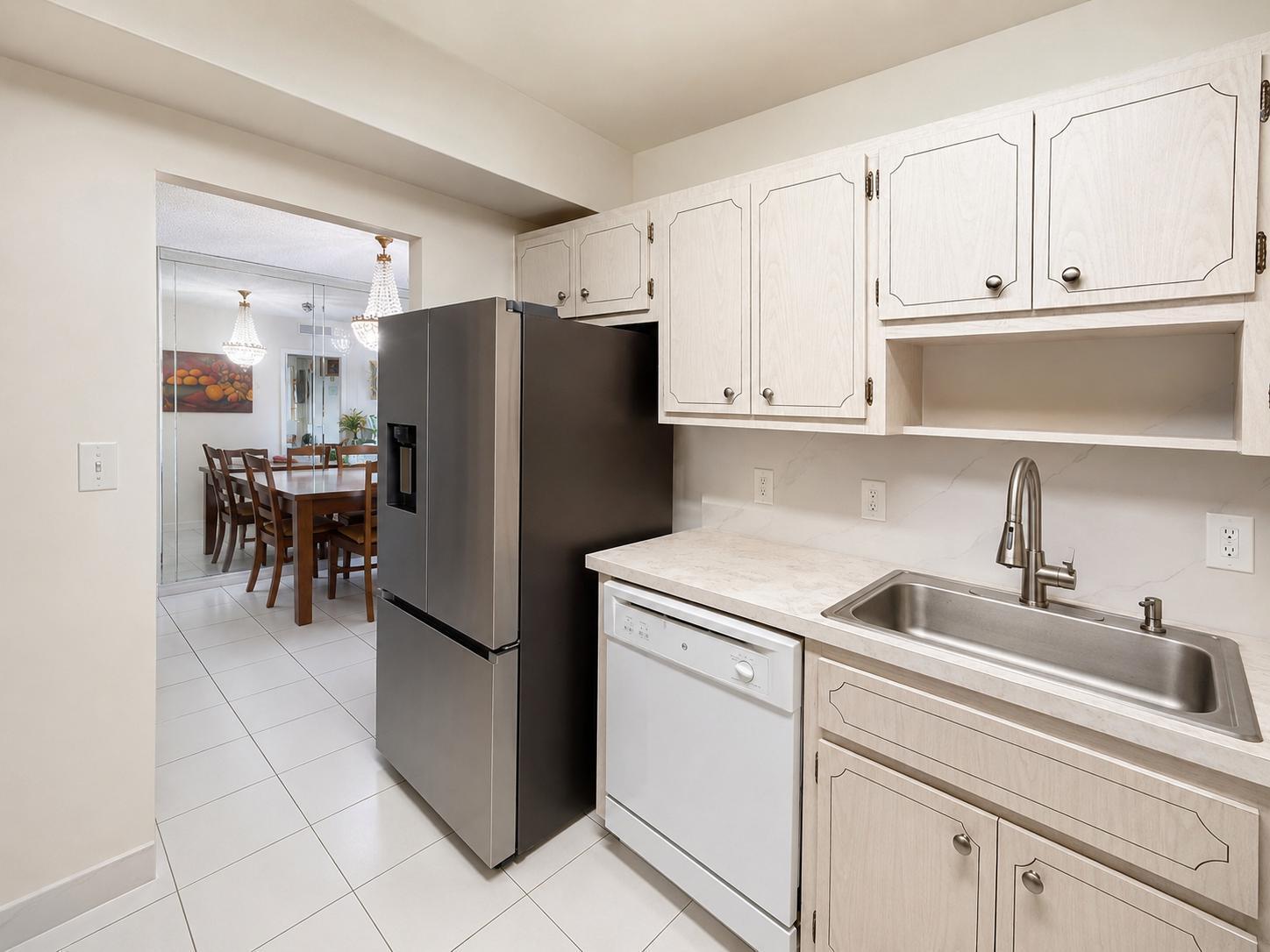 A kitchen features light wood cabinets, a stainless steel refrigerator, a white dishwasher, and a sink — 1985 S Ocean Drive # 22n, FL 33009, FL